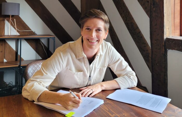 Gina Floyd signs the Peak Pickleball lease paperwork at Sheffield’s MD Law.